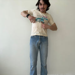 1970s If You Can Dazzle Them w Brilliance, Baffle Them w Bull Stained T-shirt That's Too Small for Cameron